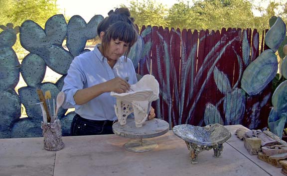 Scrap plywood cut into prickly pear shapes and painted extend a split rail fence.